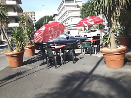 Catania: marciapiede invaso da tavolini, sedie e auto.