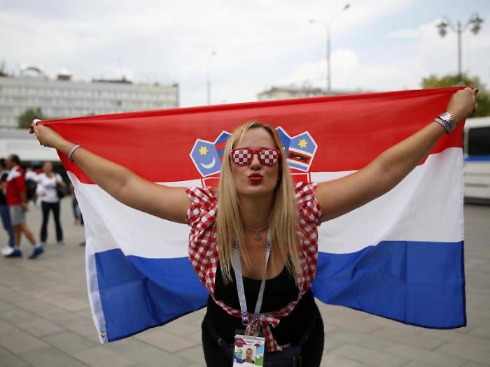 A Croatia fan poses for a picture as she arrives outside Luzhniki Stadium ahead of the final match between France and Croatia at the 2018 soccer Worl