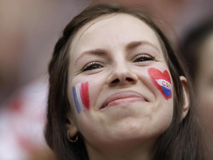 A fan waits for the start of the final match between France and Croatia at the 2018 soccer World Cup in the Luzhniki Stadium in Moscow, Russia, Sunda
