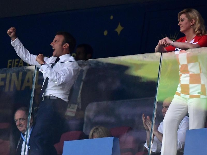 epa06890734 French President Emmanuel Macron (L) celebrates the 2-1 lead next to Croatian President Kolinda Grabar-Kitarovic (R) during the FIFA Worl