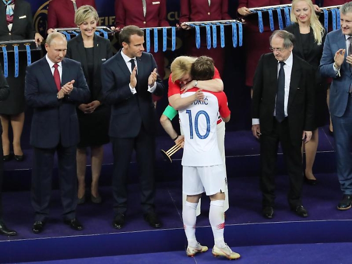 epa06891388 Crotian President Kolinda Grabar-Kitarovic hugs Croatian player Luka Modric who was awarded Player of the Tournament after the FIFA World