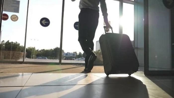 businessman-walking-airport-his-luggage-footage-079964673_iconl
