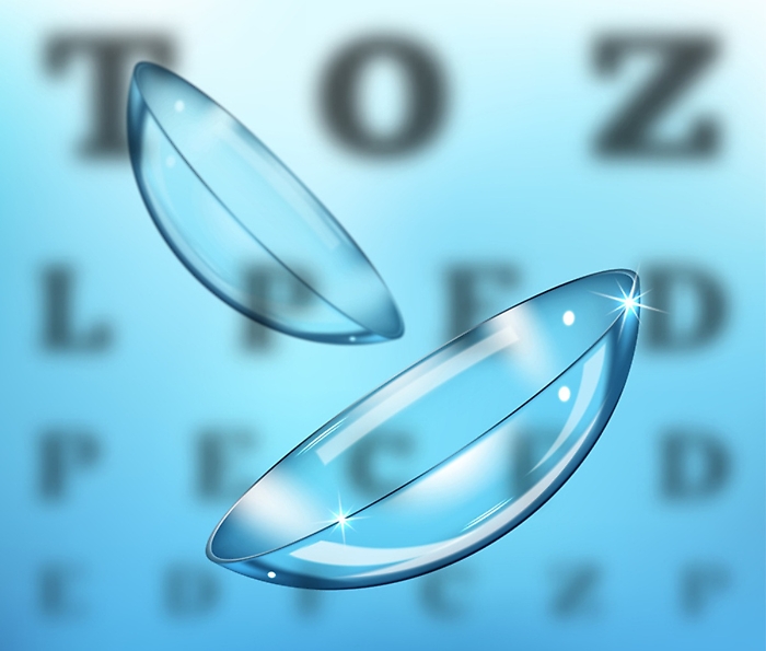 Medicine and vision concept - contact lenses on eyesight test chart background